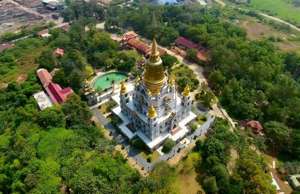 The pagoda grounds are spacious, covered by cool green canopies, creating a pure and peaceful space